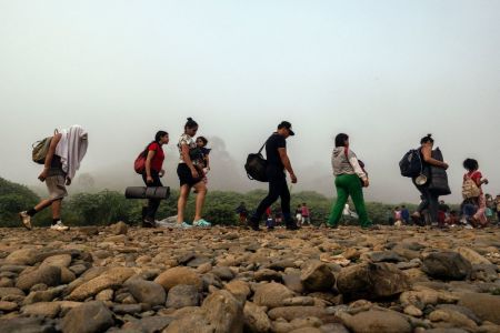 Migrants walk by the jungle near Bajo Chiquito village, the first border control of the Darien Province in Panama, on September 22, 2023. The clandestine journey through the Darien Gap usually lasts five or six days, at the mercy of all kinds of bad weather and cartels involved in human trafficking and drug smuggling .