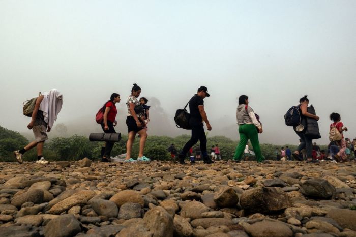 Migrants walk by the jungle near Bajo Chiquito village, the first border control of the Darien Province in Panama, on September 22, 2023. The clandestine journey through the Darien Gap usually lasts five or six days, at the mercy of all kinds of bad weather. 