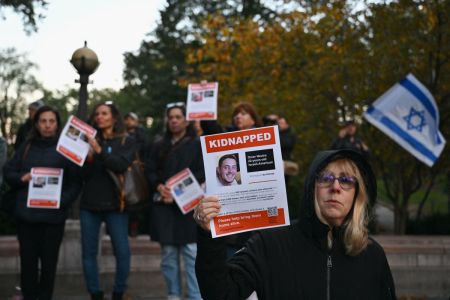 A woman holds a poster of Israeli hostage Omer Neutra during a memorial vigil for the Israeli people killed by Hamas during the October 7 attacks, in New York City on November 1, 2023.