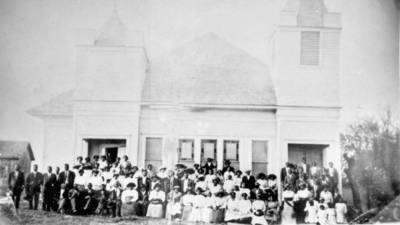 The congregation of White Rock Chapel, founded in 1884 by freed slaves, poses in front of their church in an undated photograph.