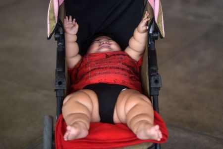 Ten-month-old Luis Gonzales is pictured in his stroller at a bus station in Colima city, Mexico on November 9, 2017.