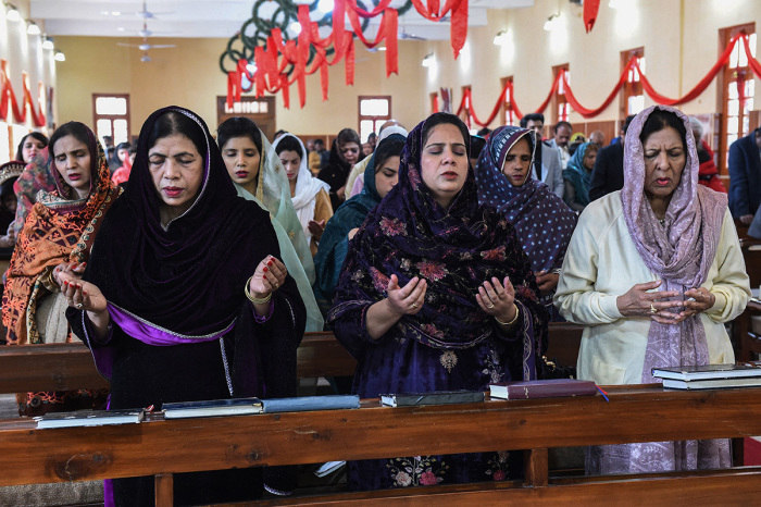 Christian devotees take part in a Christmas prayer at the Bethel Memorial Methodist church in Quetta on December 25, 2023. 