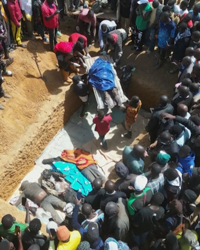This image grab made from an AFPTV video taken in Maiyanga village, in Bokkos local government, on Dec. 27, 2023, shows families burying in a mass grave their relatives killed in deadly attacks conducted by armed groups in Nigeria's central Plateau State. The death toll from a series of attacks on villages in central Nigeria has climbed to almost 200, local authorities said on December 27, 2023, as survivors began to bury the dead. Armed groups launched attacks between December 23, 2023, and December 26, 2023, in Nigeria's Plateau State, a region plagued for several years by religious and ethnic tensions. 