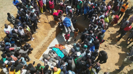 This image grab made from an AFPTV video taken in Maiyanga village, in Bokkos local government, on December 27, 2023, shows families burying in a mass grave their relatives killed in deadly attacks conducted by armed groups in Nigeria's central Plateau State. The death toll from a series of attacks on villages in central Nigeria has climbed to almost 200, local authorities said on December 27, 2023, as survivors began to bury the dead. Armed groups launched attacks between December 23, 2023, and December 26, 2023, in Nigeria's Plateau State, a region plagued for several years by religious and ethnic tensions.