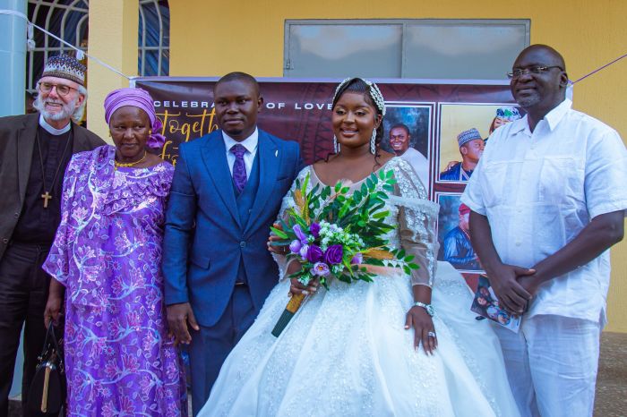 Pastor William Devlin (far left) stands next to Mary Andimi (left). Barrister Emmanuel Ogebe (far right) stands next to Agnes Egwurube (formerly Andimi) and the groom, Gabriel Egwurube. 