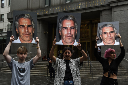 A protest group called "Hot Mess" hold up signs of Jeffrey Epstein in front of the Federal courthouse on July 8, 2019, in New York City. According to reports, Epstein will be charged with one count of sex trafficking of minors and one count of conspiracy to engage in sex trafficking of minors.