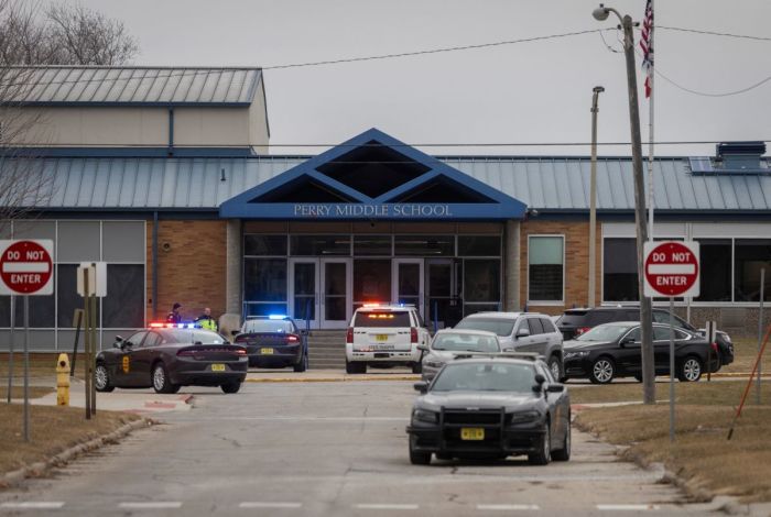 Police officers secure the campus at Perry Middle and High School during a shooting situation in Perry, Iowa, on January 4, 2024. A shooting on Thursday at the high school in Perry left 'multiple gunshot victims,' local authorities said, adding the incident was over but without confirming if anyone had been killed.