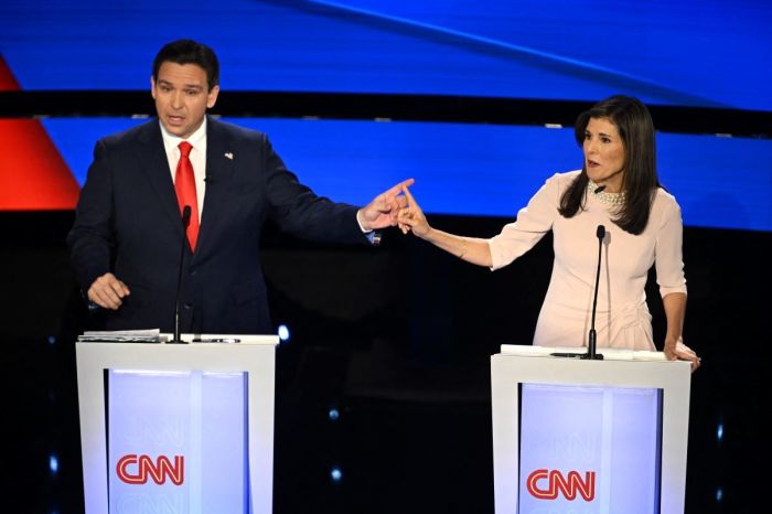 Florida Gov. Ron DeSantis (L) and former US Ambassador to the UN Nikki Haley speak during the fifth Republican presidential primary debate at Drake University in Des Moines, Iowa, on Jan. 10, 2024. 
