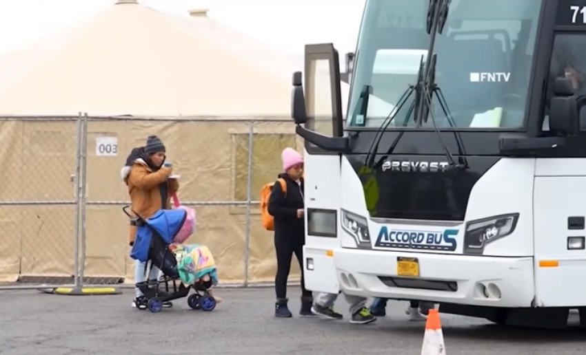 Migrants board a bus to be transported in New York City in January 2024.