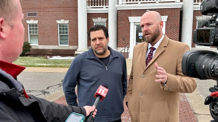 Pastor Chris Avell (L) and his attorney Jeremy Dys (R) speak to reporters outside Bryan Municipal Court in Bryan, Ohio, on January 11, 2023.