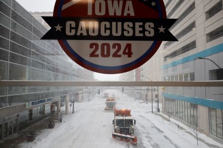 Plow trucks clear Grand Avenue as high winds and snow from winter storm Gerri four days before the Iowa caucuses on January 12, 2024, in Des Moines, Iowa. Republican presidential candidates postponed or cancelled many campaign events in Iowa days before the all-important caucuses, the first primary competition of the 2024 election year.