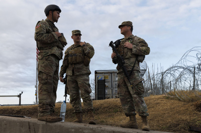 Texas National Guard soldiers wait nearby the boat ramp where law enforcement enter the Rio Grande at Shelby Park on January 26, 2024, in Eagle Pass, Texas. Gov. Greg Abbott has ordered the Texas National Guard to secure the area which has seen an unprecedented numbers of illegal crossings under the Biden administration. 