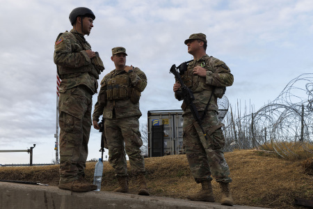 Texas National Guard soldiers wait nearby the boat ramp where law enforcement enter the Rio Grande at Shelby Park on January 26, 2024, in Eagle Pass, Texas. Gov. Greg Abbott has ordered the Texas National Guard to secure the area which has seen an unprecedented numbers of illegal crossings under the Biden administration.
