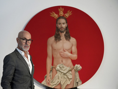 Spanish artist Salustiano Garcia poses for a photograph next to the Christ he painted for the official poster of 'Semana Santa de Sevilla 2024' (Sevilla's Holy Week celebrations) in his studio in Bormujos, near Sevilla on January 29, 2024. The official poster chosen for the Holy Week festivities in Seville (south) arouses the anger of ultra-conservatives, who demand its withdrawal, deeming it 