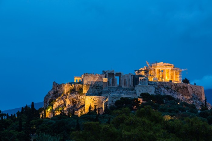 Lighted-up Acropolis and Parthenon Temple seen from the Areopagus Hill in Athens at dusk, Greece.