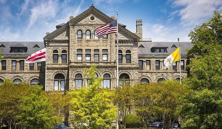 Flags fly outside McMahon Hall on the campus of Catholic University of America in Washington, D.C.