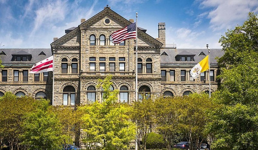 Flags fly outside McMahon Hall on the campus of Catholic University of America in Washington, D.C.