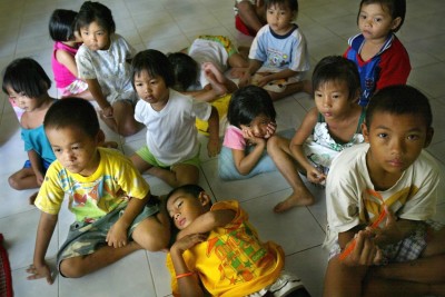 Thai orphans affected by AIDS watch television while resting at the Wat Phrabaht Nampu AIDS orphanage which is funded by the Dramaraksa Foundation July 15, 2004 in Nongmuang, Lopuri province, Thailand.  