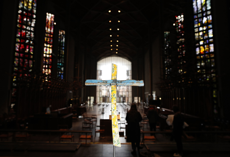 The Cross of Lampedusa stands on the altar of Coventry Cathedral on May 21, 2021, in Coventry, England.  “The Cross of Lampedusa” is made from the remains of a refugee boat wrecked near the Italian island of Lampedusa, where 311 lives were lost.