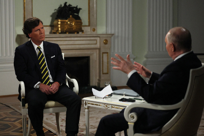 In this pool photograph distributed by Russian state agency Sputnik, Russia's President Vladimir Putin gives an interview to U.S. journalist Tucker Carlson at the Kremlin in Moscow on February 6, 2024. 