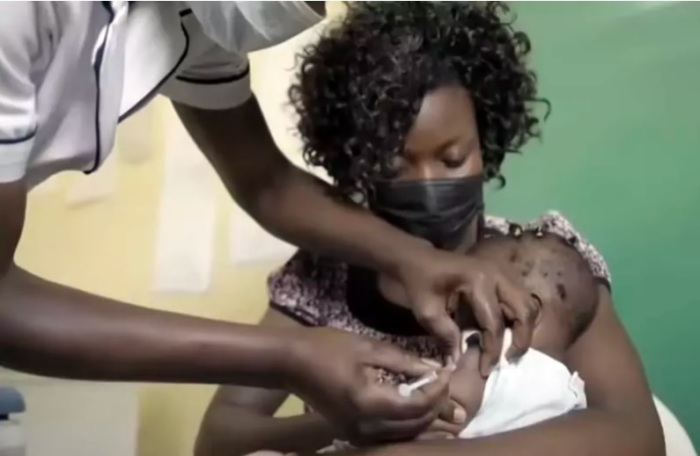 A malaria vaccine is administered to a child in Cameroon. 
