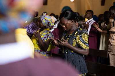 A worshiper prays while attending a mass at Ouagadougou's cathedral on June 12, 2022. 