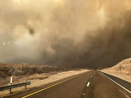In this handout photo provided by the Texas A&M Forest Service, smoke billows over a road during the Smokehouse Creek fire on February 27, 2024, in the Texas panhandle. The fire has grown to cover 1,078,086 acres as of March 2, 2024.