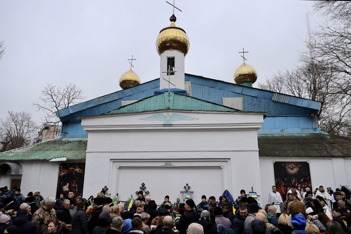People attend the funeral ceremony of members of Kravets family, killed in a drone attack on a residential building, in Odesa on March 5, 2024, amid the Russian invasion of Ukraine. 