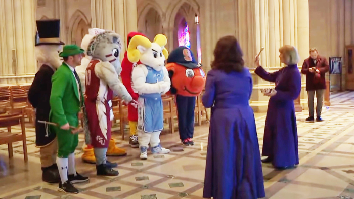Clergy at the National Cathedral in Washington, D.C., sprinkle holy water on college sports mascots ahead of the ACC Tournament at Capital One Arena.