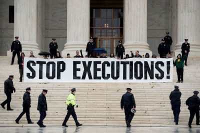Police officers gather to remove activists during an anti death penalty protest in front of the US Supreme Court January 17, 2017 in Washington, DC. 