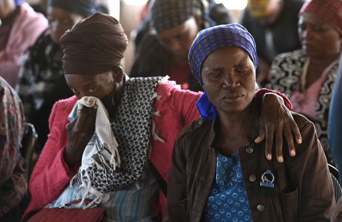 Relatives of the victims of a bus accident mourn at the Zion Christian Church (ZCC) in Molepolole in the outskirts of Gaborone on March 29, 2024. A passenger bus plunged off a bridge into a ravine in South Africa on March 28, 2024, killing at least 45 people, the South African transport ministry said. One person was also seriously injured in the crash of the vehicle heading from Botswana to Moria in the north of the country, the ministry said in a statement. 