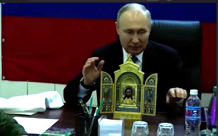 Russian President Vladimir Putin presents troops stationed in to Ukraine's annexed Kherson region with a Russian Orthodox icon that belonged to a 19th-century Russian defence minister in April 2023.