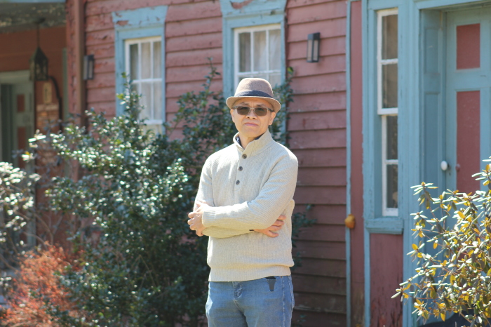 Portraiture artist Zimou Tan outside a historic building in Wingdale, N.Y., he plans to turn into a gallery and a hub for artists.