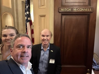 Ukraine Freedom Project Founder Steven Moore (M), the group's COO Anna Shvetsova (L) and Vice President of Public Policy Karl Ahlgren (R), outside the office of Republican Sen. Mitch McConnell of Kentucky  