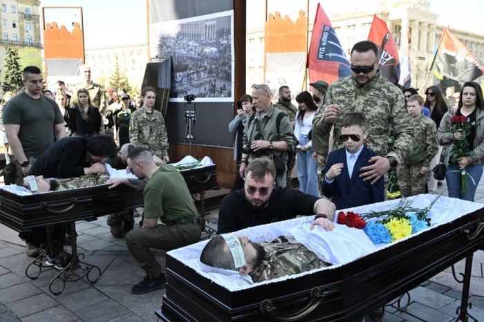 (Graphic content) Relatives, friends and comrades pay last respect during farewell ceremony for Ukrainian servicemen Sergii Konoval, call sign 'Nord', and Taras Petryshyn, call sign 'Chimera', who were killed fighting Russian troops in Donetsk region, at the Independence Square in Kyiv, on April 9, 2024, amid the Russian invasion of Ukraine.