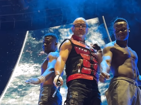Sword swallower Alex Magala (C) perform with fellow acrobats the Ramadhani Brothers at the Stronger Men's Conference hosted by James River Church on Friday April, 11, 2024, at the Great Southern Bank Arena in Springfield, Missouri. 