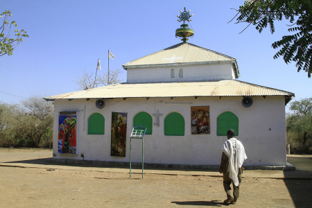 A Sudanese man walks in the courtyard of a church in the Um Gulja former refugee camp in Sudan's eastern Gedaref state on Dec. 15, 2023.
