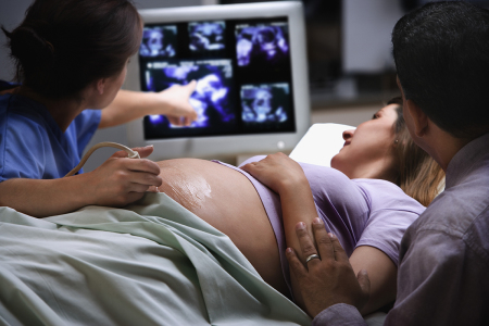 A pregnant woman undergoing an ultrasound.