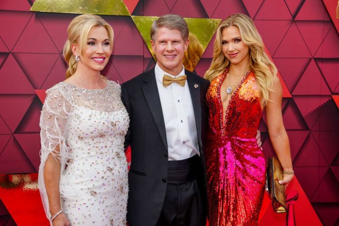 Clark Hunt with his wife, Tavia Shackles, and daughter Gracie Hunt walking the red carpet at the Kansas City Chiefs ring ceremony at Union Station on June 15, 2023, in Kansas City, Missouri. 