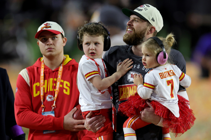 Harrison Butker #7 of the Kansas City Chiefs celebrates with his children after kicking the go ahead field goal to beat the Philadelphia Eagles in Super Bowl LVII at State Farm Stadium on February 12, 2023, in Glendale, Arizona. 