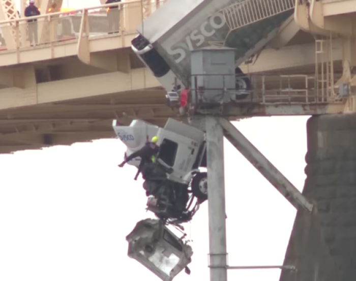 A truck driver is rescued after her truck careened over the side of the George Rogers Clark Memorial Bridge in Louisville, Kentucky, due to a multi-car crash on March 1, 2024. 
