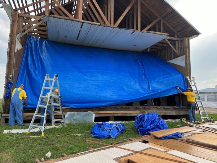 Volunteers with Texans on Mission help erect a tarp to limit damage to Dyess Grove Baptist Church in Temple, Texas, after a tornado struck the town on May 22, 2024.