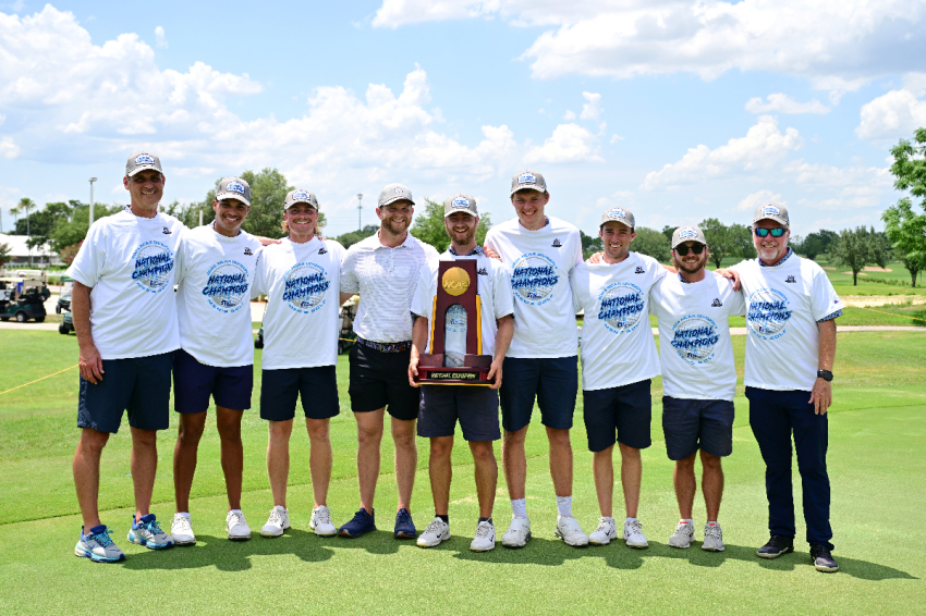 Members of the Colorado Christian University Men's Golf Team pose with a trophy after winning the NCAA National Title.