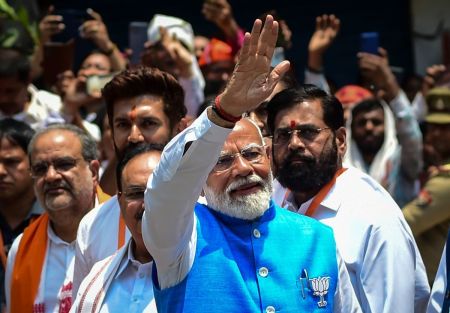 India's Prime Minister Narendra Modi (C), surrounded by other party leaders and MPs including Home Minister Amit Shah and Uttar Pradesh Chief Minister Yogi Adityanath, greets supporters after filing nomination papers on May 14, 2024 in Varanasi, India.