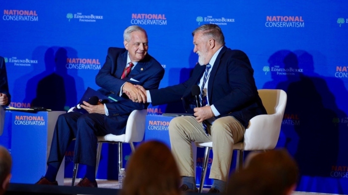 Theologian Albert Mohler, left, and Pastor Douglas Wilson, right, shake hands during a discussion Tuesday at the fourth annual National Conservatism Conference (NatCon 4) in Washington, D.C., on July 9, 2024. 