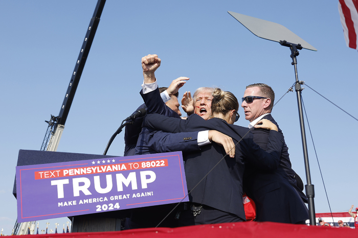 Republican presidential candidate former President Donald Trump is rushed offstage after an assassination attempt on his life during a rally on July 13, 2024, in Butler, Pennsylvania. 