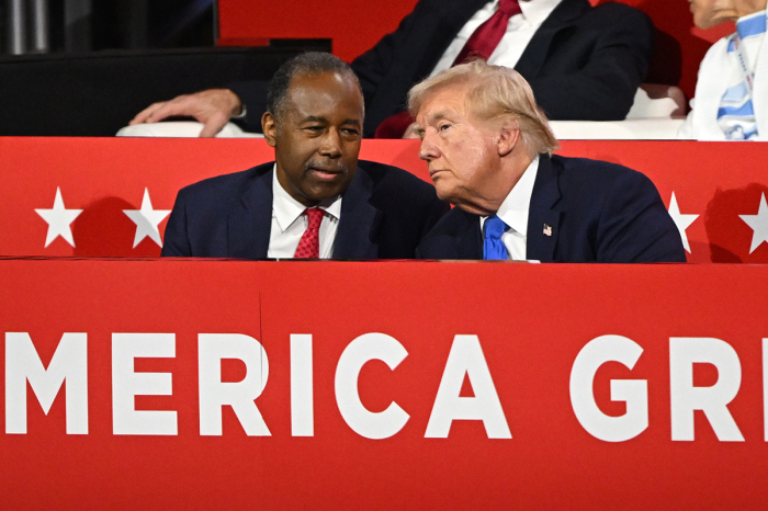 Former Housing and Urban Development Secretary Dr. Ben Carson speaks with Republican presidential candidate, former U.S. President Donald Trump on the second day of the Republican National Convention at the Fiserv Forum on July 16, 2024, in Milwaukee, Wisconsin. Delegates, politicians, and the Republican faithful are in Milwaukee for the annual convention, concluding with former President Donald Trump accepting his party's presidential nomination. The RNC takes place from July 15-18. 