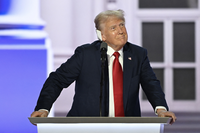 Former U.S. President and 2024 Republican presidential candidate Donald Trump arrives onstage to accept his party's nomination on the last day of the 2024 Republican National Convention at the Fiserv Forum in Milwaukee, Wisconsin, on July 18, 2024. Days after he survived an assassination attempt Trump won formal nomination as the Republican presidential candidate and picked Ohio U.S. Sen. J.D. Vance for running mate. 