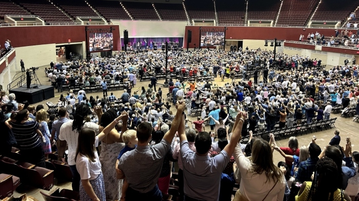 Congregants of First Baptist Dallas raise their hands in solidarity as they sing the doxology at the close of their service in the Kay Bailey Hutchison Convention Center on July 21, 2024, in Dallas, Texas.