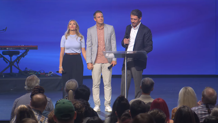 James and Bridgette Morris (L), the son and daughter-in-law of Gateway Church founder Robert Morris receive a standing ovation from parishioners on Sunday July 28, 2024.